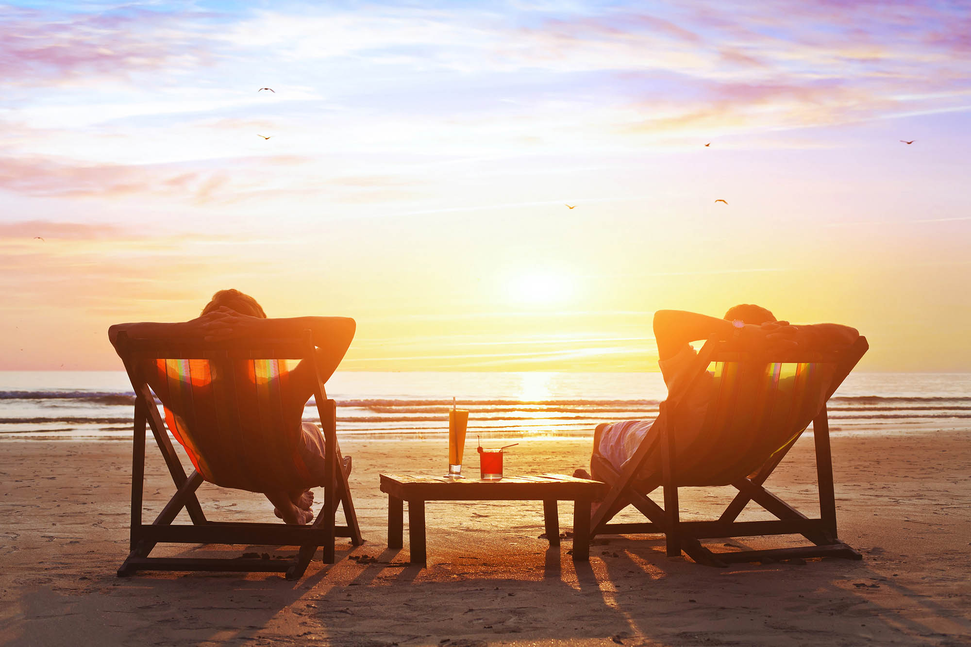happy couple enjoy luxury sunset on the beach during summer vaca